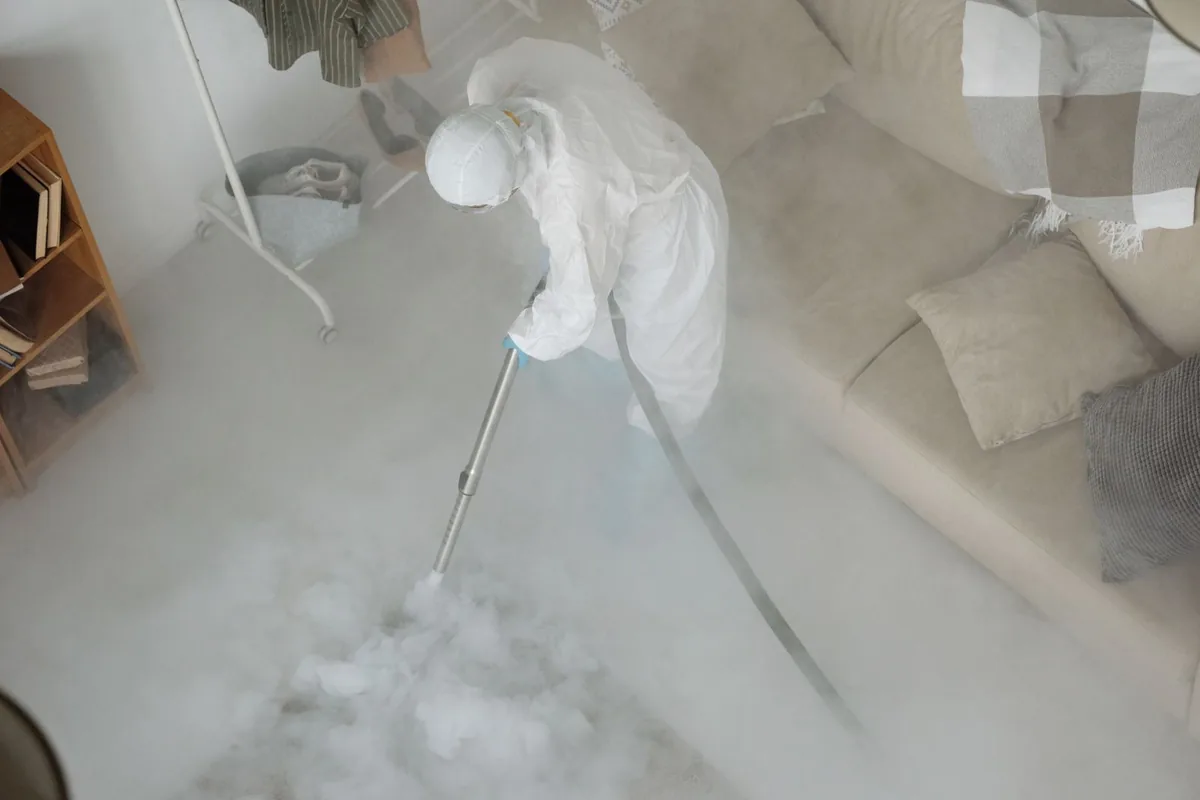 Biohazard cleanup technician in protective equipment, Mendota, CA